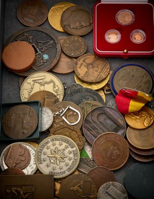 a red box filled with coins and a red keychain
