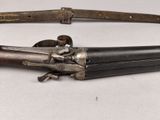 an old gun that is on display on a table