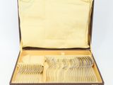 a brown case with silverware in it on a white surface
