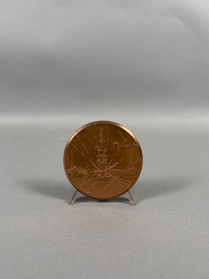 une petite pièce posée sur un petit socle, sur une surface blanche