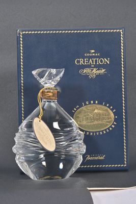 an image of a bottle of creation perfume next to a box