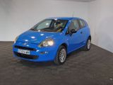 the small blue car is parked in a large room
