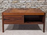 a wooden coffee table with two drawers on it
