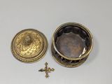 an image of a small gold box with a cross on it