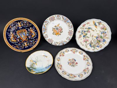 four plates with different designs on them sitting on a table