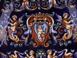 a picture of a decorative plate with angels and cherensils