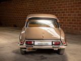 a car that is parked in a garage next to a brick wall