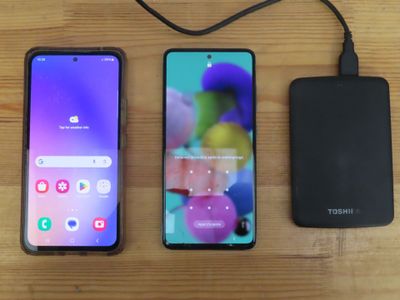 two samsung galaxy s10e smartphones next to each other on a wooden table