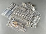 a lot of silverware in plastic bags on a table