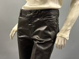 a mannequin wearing a pair of black pants and a white shirt