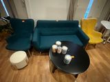 a living room with a couch, coffee table, and chairs