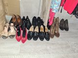 several pairs of women ' s shoes are lined up against a wall