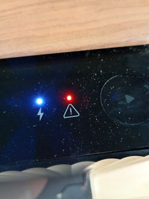 a close up of a cell phone with a red light on it