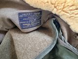 un ours en peluche qui se trouve à l'intérieur d'une veste