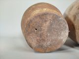 two brown vases sitting next to each other on a white surface