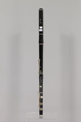 a close up of a black and white clarinet on a clear stand