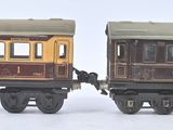 two toy trains sitting side by side on a white surface