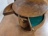 a wooden table with a green chair inside of it