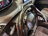 a steering wheel and dashboard of a car with a digital display