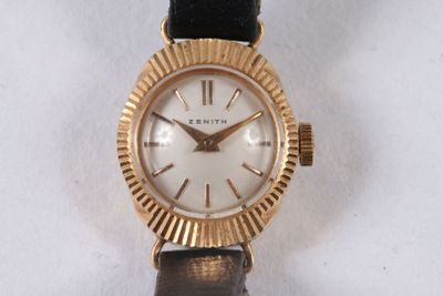 a gold wrist watch with a white face on a black strap