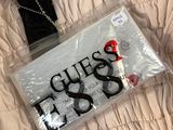 a bag with a name tag on it on a bed