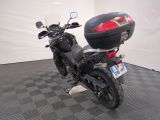 a motorcycle that is parked in a room with a checkered floor