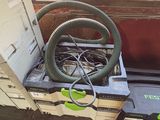 a green hose sitting on top of a box next to a green chair