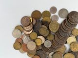 a pile of coins sitting on top of a white table