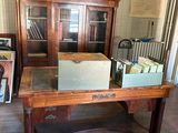 a desk with a lot of books on it in a room