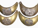 three brass plated bowls with designs on them on a white surface
