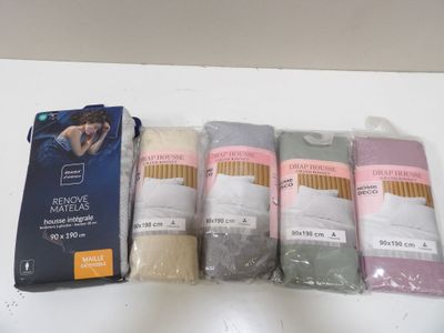 five pairs of socks sitting on a table next to a package of tissues