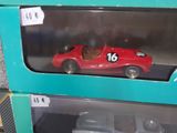 a red toy car in a box with a number on it