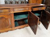 a wooden cabinet with two doors open on the floor