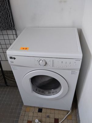 a white washer and dryer in a small room