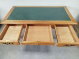 an image of a wooden desk with two drawers and a green top