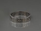 a close up of a silver ring with screws on it