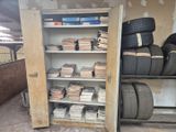 de nombreux pneus empilés sur les étagères du garage