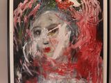 painting of a woman ' s face with red hair in a black frame