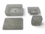 four pieces of glass with a candle and soap dish on a white surface