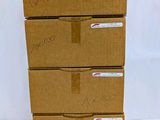 four cardboard boxes stacked on top of each other on a white surface