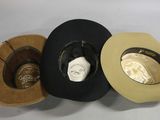 several hats are lined up on a white surface