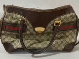 beige and brown gucci handbag with red, green, and red stripes