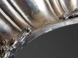 a close up of a silver vase on a table
