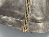 a close up of a leather jacket with a zipper on it