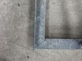 a measuring tape on the ground next to a metal frame