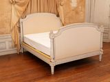 a bed with a canopy in a room with a wooden floor