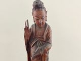 statue of a woman holding a flower in her right hand