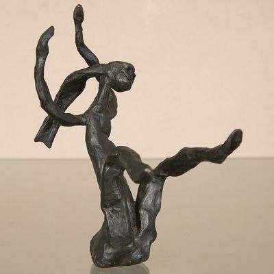 bronze sculpture of a woman with a bird on her shoulder