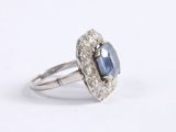 a white gold ring with a blue sapphire and diamonds