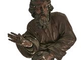 une statue représentant un homme barbu tenant une balle